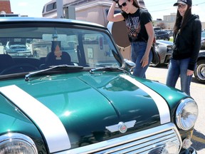 BRIAN KELLY 
Kaitlyn Lundrigan and her sister, Chelsea Lundrigan, check out a Mini Cooper on display at the fourth annual Queen Street Cruise Festival at GFL Memorial Gardens on Saturday. The car was a standout for Chelsea. "Look, it's my size," she said. Chelsea was also drawn to the shade of green featured on a nearby 1969 Pontiac Lemans. "It's one of a kind," she said. "It drew me in. I had to come over and check it out." Chelsea and Kaitlyn's father, Michael, owns a 1969 Plymouth Road Runner.