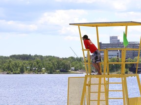 A lifeguard surveys the main beach at Bell Park in Sudbury, Ont. on Monday June 17, 2019. John Lappa/Sudbury Star/Postmedia Network