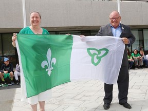 Joanne Gervais, executive director of L'Association canadienne-francaise de l'Ontario du grand Sudbury, and Greater Sudbury Mayor Brian Bigger take part in a Franco-Ontarian flag-raising ceremony to celebrate Saint-Jean-Baptiste Day at Tom Davies Square in Sudbury, Ont. on Monday June 24, 2019.