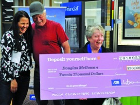 Doug and Gloria McGowan were shocked to learn Friday at the ATB Financial branch in Nanton that Doug had won $20,000 through an ATB Financial contest. Julie Swennumson, manager of Nanton’s ATB branch, presented the large ceremonial cheque to the couple, who were delighted by the news once the wrapping around the cheque was removed.