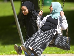 Omaima Al-Hajaly swings in Springbank Park with her daughter, Beal student Judy Kurbaj, 15, on Monday June 3, 2019. Mike Hensen/The London Free Press/Postmedia Network