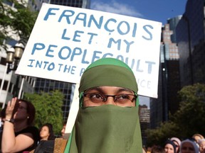 People protest Quebec's Bill 21, which bans teachers, police, government lawyers and others in positions of authority from wearing religious symbols such as Muslim head coverings and Sikh turbans, in Montreal in June 2019. Conservative Leader Erin O'Toole said he would not touch the law if elected prime minister and debased himself by doing so.