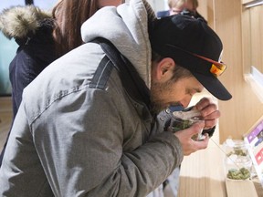 Jason Geldhof sniffs a marijuana sample prior to making the first legal retail purchase of marijuana in the history of London, Ont. on Monday April 1, 2019. Geldhof drove 80 minutes from his home in Goderich to be the first person in line at Central Cannabis, a store which began selling marijuana and related products Monday. Geldhof plans to frame his historic receipt. Derek Ruttan/Postmedia Network