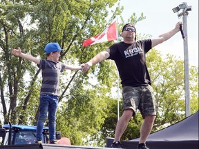 Aryk Kinnear, 7, from Finch, assists master of ceremonies Dillion Vanier as members of the Krusher Stunt BMX team jump over them during a performance at the Avonmore Fair, on Sunday July 21, 2019 in Avonmore, Ont. Phillip Blancher/Special to the Cornwall Standard-Freeholder/Postmedia Network