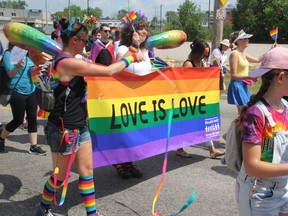 Marchers on Memorial Drive hold a ‘Love is Love’ banner at the North Bay Pride march, July 20, 2019. Nugget File Photo