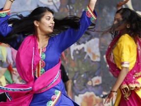 Punjabi dancers Navkivan Safri (left) and Arwinder Rupana (right) dance on the main stage during the Heritage Day events at Muskoseepi Park on Monday August 7, 2017 in Grande Prairie, Alta.