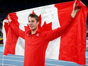 Derek Drouin of Corunna, Ont., celebrates with the Canadian flag after winning the gold medal in the men's high jump at the Rio 2016 Olympic Games at the Olympic Stadium on Aug. 16, 2016, in Rio de Janeiro, Brazil.  (Photo by Ian Walton/Getty Images)