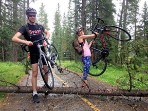 Overcoming Obstacles
Josh Hartloper and Asia Walker lift their bikes over a tree that was blown down in strong winds across the Legacy Trail on Saturday, July 27, 2019. A heavy downpour soaked cyclists on the trail. photo by Pam Doyle/pamdoylephoto.com