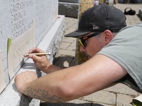 JohnStewart LeBaron prepares the stencilled name of his cousin, David Alwyn "Al" Forneri, for sandblasting into a monument Monday, July 15, 2019 in Belleville. Belleville council is to consider a request by a city resident to add a name to the Second World War monument.