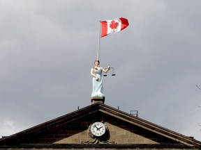 The flag blows wildly over Sally Grant atop the Brockville courthouse on a blustery Wednesday afternoon, April 3, 2019 in Brockville, Ont. A new sexual assault allegation surfaced this week against Ryan Hartman, who was due back in court for a bail decision on Thursday morning. Ronald Zajac/Brockville Recorder and Times/Postmedia Network
