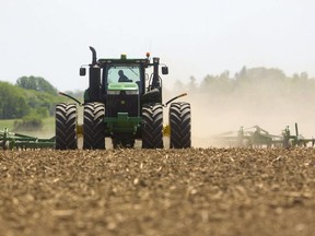 Dust clouds over fields means the soil is finally drying up, as farmers rush to plant their crops in southwestern Ontario earlier in June. Farmers suffer from the same mental health problems as non-farmers: depression, anxiety, panic attacks, burnout. But so much in farming is beyond an individual producer's control, which exacerbates the problem, say advocates. File photo/Postmedia Network