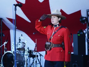 A Mountie salutes during the singing of the national anthem on Canada Day in Lamoureux Park on Monday July 1, 2019 in Cornwall, Ont. Nick Dunne/Cornwall Standard-Freeholder/Postmedia Network