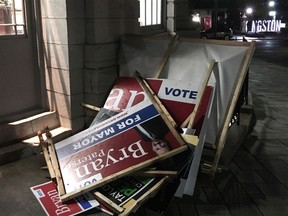 Election signs sit piled near Kingston Cty Hall's back door on the night of the 2018 municipal election.