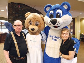 Gerry Antoine, left, and his wife, Noella Beaudry, give Sudbrina and Sud-Berry Bear a hug at the Amberwood Suites Blueberry Social in Sudbury, Ont. on Wednesday July 17, 2019.