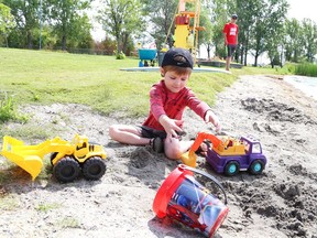 Cameron Maki, 4, plays on the beach under the watchful eye of his mom, at Whitewater Lake Park in Azilda in this file photo.