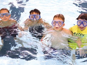 Alex Cadotte, 9, left, Rhys Johnson-Calixte, 9, Parker Watson, 10, and Olivia Aelick, 9, enjoy a swim in the refurbished pool at the YMCA in Sudbury, Ont. on Monday July 29, 2019. Pools, with restrictions, can reopen Monday. John Lappa/Sudbury Star/Postmedia Network