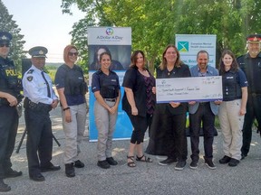 The Mental Health Engagement and Response Team (MHEART), seen here receiving a donation from the Dollar A Day foundation, secured permanent funding from the South West LHIN that will also expand the program. The program has crisis clinicians from CMHA Oxford paired with police officers to help respond to mental health and addictions calls.

Submitted photo