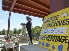 Heritage group chair Gabrielle Di Francesco spoke from a stepladder to dozens who attended Southampton Cultural Heritage Conservancy's rally to save the former St. Paul's Anglican Church rectory, which overlooks Fairy Lake in the background, June 30 in Southampton.