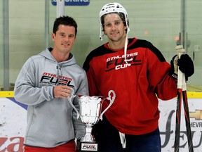 Captain Seth Griffith, right, receives the championship trophy from tournament organizer Colin Roeszler after Team Griffith won the Athletes Fuel Cup final at Thames Campus Arena in Chatham, Ont., on Wednesday, Aug. 14, 2019. Mark Malone/Chatham Daily News/Postmedia Network