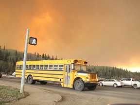 A school bus carrying children from a school in the subdivision of Abasand drives through an intersection in Fort McMurray, Alta. on Tuesday May 3, 2016. Robert Murray/Fort McMurray Today/Postmedia Network