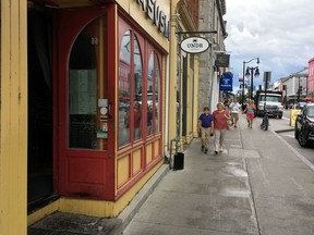Kingston city council deferred a plan to prohibit businesses from leaving their doors open while their air conditioning systems are running.