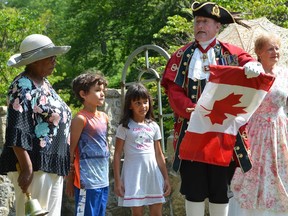 Town crier Bruce Kruger re-dedicates the black history cairn during a ceremony at Harrison Park on Saturday, August 3, 2019 in Owen Sound, Ont. With Kruger, from left, are Senator Wanda Thomas Bernard of Nova Scotia, Noah Sheffield, 7, and Naomi Ruff, 5, who rang Kruger's Bell during the ceremony, along with his wife Lynn, right. Durign the ceremony, which was part of the Owen Sound Emancipation Festival, Kruger was declared the Official Town Crier of the Emancipation. Rob Gowan/The Owen Sound Sun Times/Postmedia Network