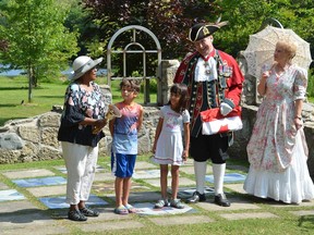 Town crier Bruce Kruger re-dedicates the black history cairn during a ceremony at Harrison Park on Saturday, August 3, 2019 in Owen Sound, Ont. With Kruger, from left, are Senator Wanda Thomas Bernard of Nova Scotia, Noah Sheffield, 7, and Naomi Ruff, 5, who rang Kruger's Bell during the ceremony, along with his wife Lynn, right. During the ceremony, which was part of the Owen Sound Emancipation Festival, Kruger was declared the Official Town Crier of the Emancipation. Rob Gowan/The Owen Sound Sun Times/Postmedia Network