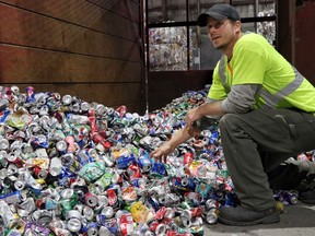 Andrew Miron, facility supervisor at Green For Life Environmental, checks aluminum cans for contamination.