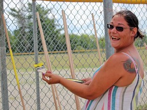 Amanda Cress, Pow Wow committee member, paints part of the event's display at the Garden River Baseball Fields to prepare the new Pow Wow grounds. FILE