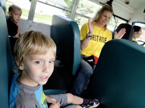 In this file photo, Matteo Mastroianni,  looks out the windows, left, as he rides the bus with Aiden Deschene, background, driver safety instructor Serena Morgan and bus driver Marie Whittal during a previous First-Time Rider Orientation Day at Ursuline College in Chatham. This year's orientation day is Aug. 20 in Chatham.
