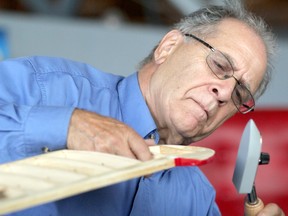 Rino Zorzi, secretary of Sault Ste. Marie Model Airplane Radio Club, uses a sealing iron on a plane he's making using balsa wood during Bushplane Days at Canadian Bushplane Heritage Centre in Sault Ste. Marie, Ont., on Saturday, Sept. 21, 2019. (BRIAN KELLY/THE SAULT STAR/POSTMEDIA NETWORK)
