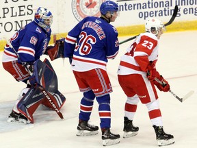 Soo Greyhounds centre Rory Kerins (right) and Kitchener Rangers defenceman Ville Ottavainen watch the play in front of Rangers goaltender Jacob Ingham during first-period OHL play at GFL Memorial Gardens Friday, Sept. 27, 2019 in Sault Ste. Marie, Ont. JEFFREY OUGLER/THE SAULT STAR/POSTMEDIA NETWORK