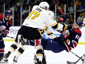Sarnia Sting's Owen Saye (17) hits Saginaw Spirit's Cole Perfetti (91) in the first period at Progressive Auto Sales Arena in Sarnia, Ont., on Friday, Sept. 27, 2019. (Mark Malone/Chatham Daily News/Postmedia Network)