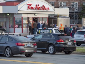 Customers line up at a Tim Hortons on Sunday, Sept. 8, 2019. The City of Fredericton will spend $40,000 to direct motorists around a busy Tim Hortons, in the latest move by a Canadian municipality to curb traffic headaches and other concerns caused by restaurant drive-thrus. THE CANADIAN PRESS/Andrew Vaughan