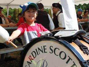 Felix Sani, 3, tries his hand at playing the drums while members of the Kincardine Scottish Pipe Band took a break for some lunch on Saturday, August 31, at the Kincardine Fall Fair. Hannah MacLeod/Kincardine News