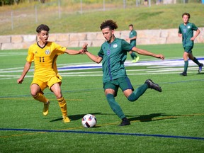 Austin Munro of the Nipissing Lakers takes a shot as Nick Esperanca of the Laurentian Voyageurs challenges during OUA action Saturday at Nipissing Univesity. The Lakers defeated Laurentian 2-1.
Submitted Photo