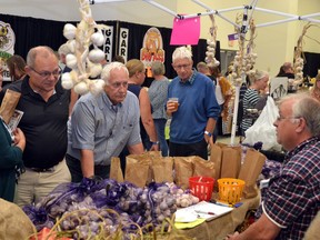 Iam Williamson of Glorious Garlic in Fergus chats with customers about growing garlic at the Stratford Kiwanis Garlic Festival in this file photo from 2019.