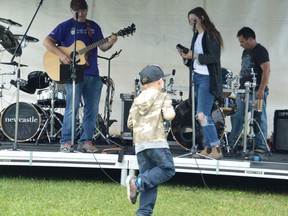 Avery Bazinet, foreground, gets into the groove as family members Rod and Kass Bazinet perform on stage during Labour Day in the Park in this file photo.