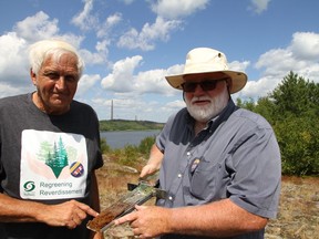 Professors Peter Beckett (left) and Graham Speirs from Laurentian University are pioneers within Sudbury's regreening efforts. With the Superstack in the background, they presented to a Canadian Ecology Centre's mining teachers tour in September of last year.
