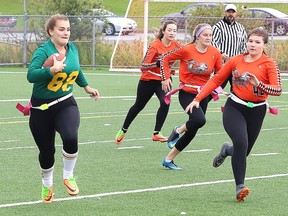 Kennedy Ward, left, of the Lockerby Vikings, runs for a first down during flag football action against the Lasalle Lancers at James Jerome Sports Complex in Sudbury, Ont. on Wednesday September 25, 2019.
