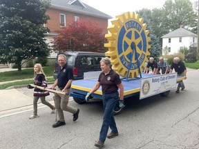 Members of the Dresden Rotary Club push and pull a float with a giant Rotary insignia through the whole Terry Fox Run course in Dresden on Sept. 15. Jake Romphf photo
