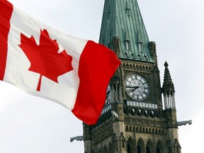 The Canadian flag flies on Parliament Hill in Ottawa.