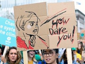 A participant holds a drawing depicting Swedish environmental activist Greta Thunberg during a protest march to call for action against climate change, in The Hague, Netherlands September 27, 2019.