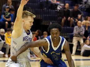 Haroun Mohamed (23) of the Laurentian Voyageurs handles the ball while Julius Laurinavicius (5) of the Western Mustangs defends during the Voyageurs pre-season tournament, hosted at Laurentian's Ben Avery Gym, on Saturday, September 28, 2019.