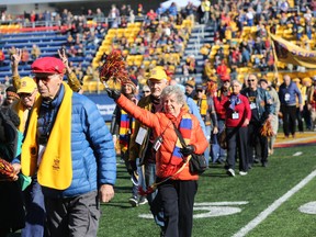 Queen's University alumni marched in the Tricolour Guard Alumni Parade to mark their milestone anniversaries of 50 or more years during the Homecoming football game at Richardson Stadium on Oct. 19, 2019.