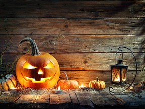 Jack O' Lantern On Wooden Table With Lantern (Getty Images)