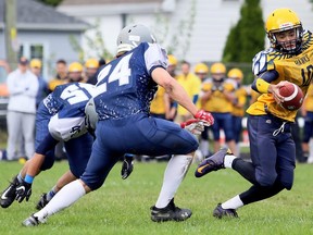 Chatham-Kent Golden Hawks quarterback Ethan Jordan (10) tries to elude Ursuline Lancers' Logan Stefina (24) in the first quarter of an LKSSAA senior football game at Ursuline College Chatham in Chatham, Ont., on Friday, Oct. 4, 2019. Mark Malone/Chatham Daily News/Postmedia Network