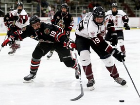 Chatham Maroons' Tate Bowden (89) is checked by Sarnia Legionnaires' Drayton Todoroff (19) in the third period at Chatham Memorial Arena in Chatham, Ont., on Sunday, Oct. 6, 2019. Mark Malone/Chatham Daily News/Postmedia Network