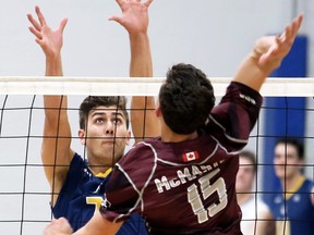 Windsor Lancers' Pierce Johnson (7) of Chatham, Ont., tries to block McMaster Marauders' Francois Albert (15) during a men's volleyball exhibition match at Ursuline College Chatham in Chatham, Ont., on Friday, Oct. 18, 2019. The Marauders won in five sets (13-25, 25-20, 31-29, 18-25, 15-13). Mark Malone/Chatham Daily News/Postmedia Network