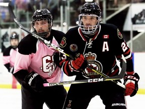 Chatham Maroons' Dallas Anderson (10) and Sarnia Legionnaires' Josh Barraclough (23) jockey for position in the third period during the Maroons' annual breast cancer awareness night at Chatham Memorial Arena in Chatham, Ont., on Sunday, Oct. 27, 2019. Mark Malone/Chatham Daily News/Postmedia Network